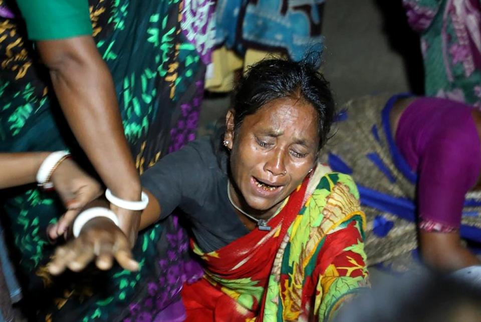 A relative of a victim who died after a boat capsized in river Karotoa, weeps near Boda town on 26 September 2022 (AFP via Getty Images)