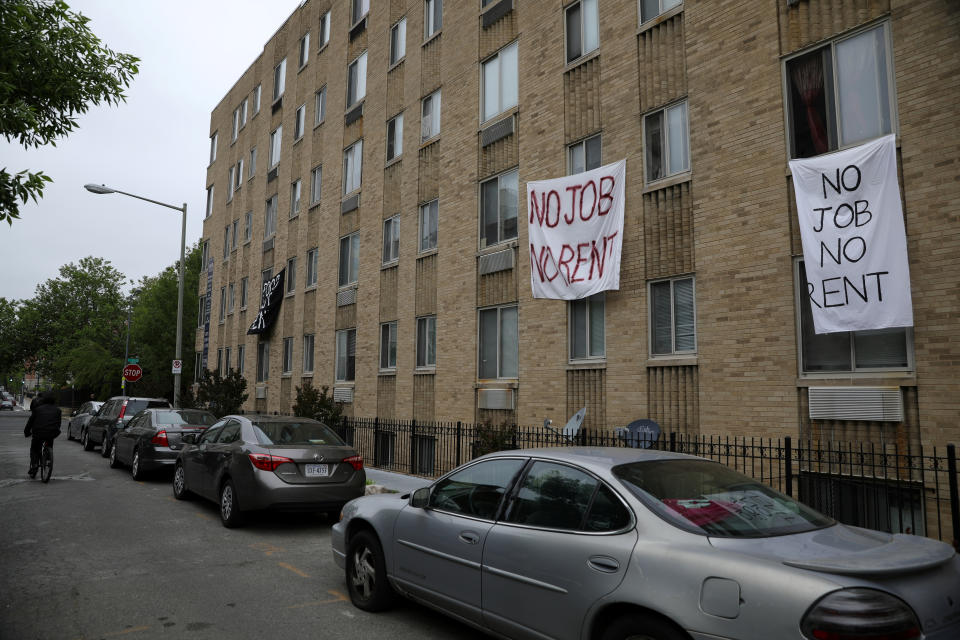Makeshift sheets displaying messages of protest contesting the ability to pay for rent hang in the window of an apartment building in the Columbia Heights neighborhood in Washington, U.S., May 18, 2020. REUTERS/Tom Brenner
