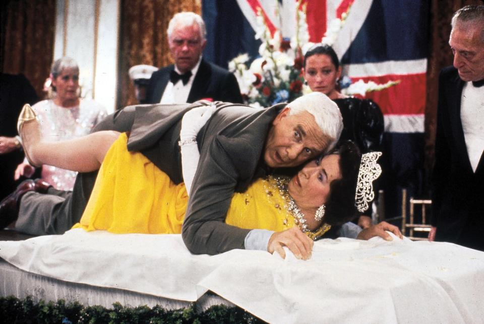 Frank Drebin (Leslie Nielsen) tries to save the queen (Jeannette Charles) in "The Naked Gun."