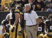 Iowa head coach Kirk Ferentz talks with his team on the sideline during the first quarter of an NCAA college football game against Colorado State, Saturday, Sept. 25, 2021, in Iowa City, Iowa. (AP Photo/Ron Johnson)