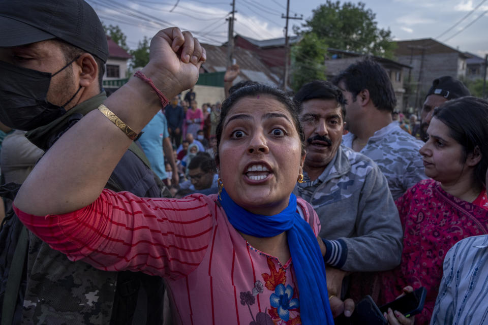 FILE- A woman from the minority Kashmiri Hindus, known as "pandits," shouts slogans as she along with others block the road during a protest against the killing of Rahul Bhat, a fellow Pandit, on the outskirts of Srinagar, Indian controlled Kashmir, Thursday, May 12, 2022. The Muslim-majority region has witnessed a spate of targeted killings in recent months. Assailants fatally shot a Hindu bank manager in Indian-controlled Kashmir on Thursday, June 2, said police, who blamed militants fighting against Indian rule for the attack. (AP Photo/Dar Yasin, File)