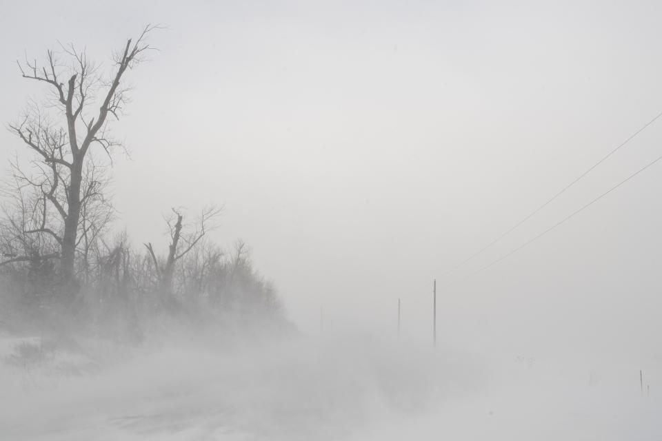 Blowing snow impairs visibility in rural Linn County, Iowa, on Friday, Dec. 23, 2022. A winter storm brought wind chill values of more than 30 degrees below zero and whiteout conditions to Eastern Iowa.