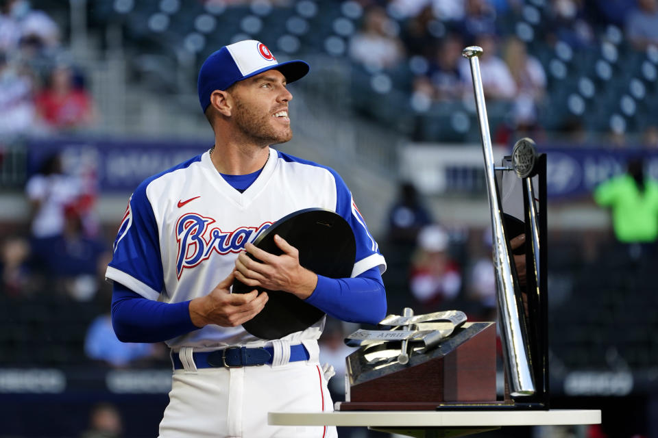 Atlanta Braves first baseman Freddie Freeman (5) holds the National League Most Valuable Player award during a ceremony before a baseball game against the Philadelphia Phillies Sunday, April 11, 2021, in Atlanta. (AP Photo/John Bazemore)