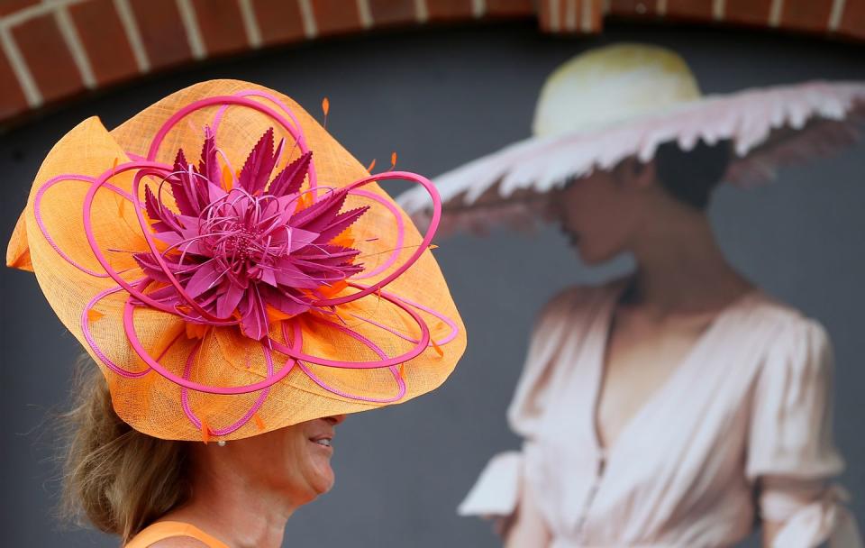 <p>One attendee wore a vibrant orange and pink flower-burst hat.</p>