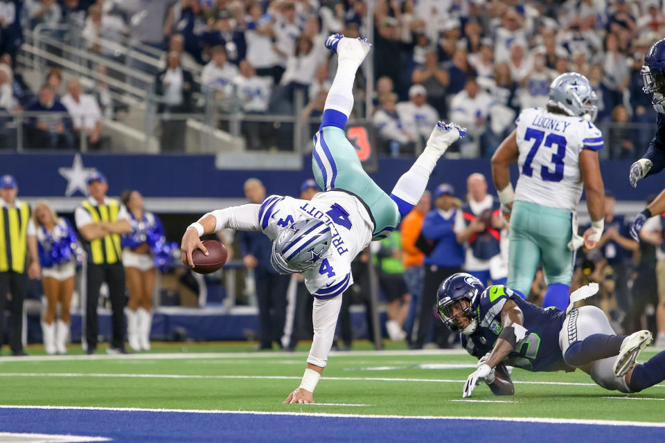 Cowboys quarterback Dak Prescott dives for the end zone during the NFC wild-card game against the Seahawks. Prescott ran for a score, threw for another, and completed 22 of 33 passes for 226 yards and an interception in Saturday’s win. (Getty Images)