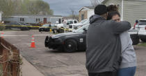 Family and friends of the victims who died in a shooting, comfort each down the street from the scene in Colorado Springs, Colo., on Sunday, May 9, 2021. The suspected shooter was the boyfriend of a female victim at the party attended by friends, family and children. He walked inside and opened fire before shooting himself, police said. Children at the attack weren’t hurt and were placed with relatives.(Jerilee Bennett/The Gazette via AP)