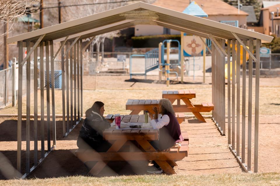 Two women have lunch at Jaurequi Park on Tuesday, March 1, 2022, in Silver City, New Mexico. The park is located in Chihuahua Hill, the town's oldest Mexican American neighborhood.