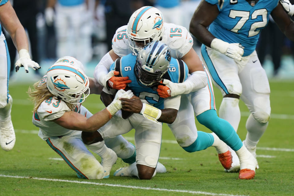 Miami Dolphins outside linebacker Jaelan Phillips (15) and inside linebacker Andrew Van Ginkel (43) sack Carolina Panthers quarterback P.J. Walker (6) during the second half of an NFL football game, Sunday, Nov. 28, 2021, in Miami Gardens, Fla. The Dolphins defeated the Panthers 33-10. (AP Photo/Wilfredo Lee)