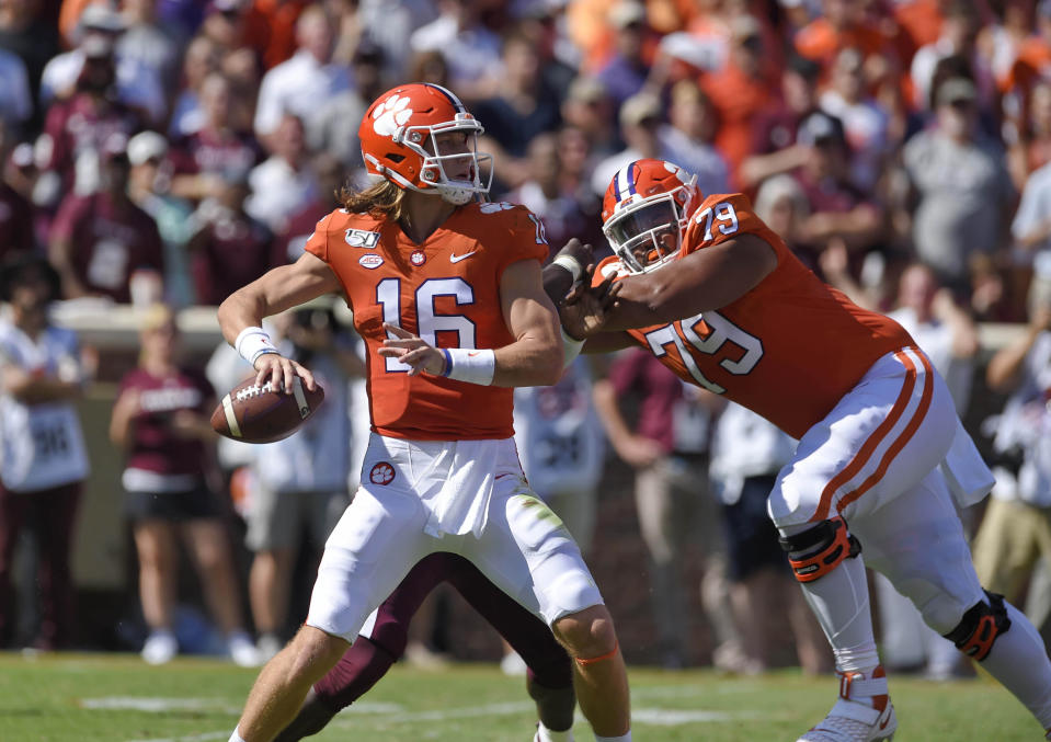 File-This Sept. 7, 2019, file photo shows Clemson quarterback Trevor Lawrence dropping back to pass with blocking help from Jackson Carman (79) during the second half of an NCAA college football game in Clemson, S.C. Carman is one of the few recent five-star recruits from Ohio who didn't end up at Ohio State. Now the two schools meet in the CFP semifinals, where Carman will be matched up against Ohio State's star defensive lineman Chase Young. (AP Photo/Richard Shiro, File)