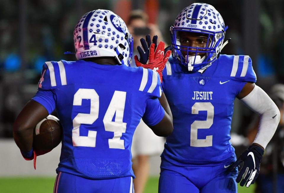 Joquez Smith (24) of Jesuit celebrates a touchdown with teammate Junior Vandeross (2) during first quarter of the Class 6A state championship game against Pine Forest at DRV PNK Stadium, Fort Lauderdale, FL  Dec. 17, 2021. 