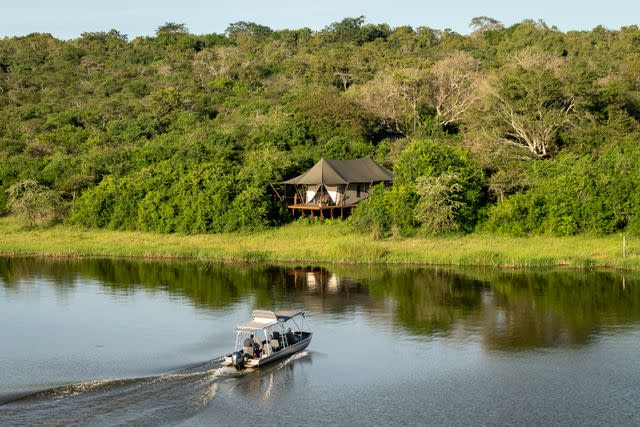 <p>Courtesy of Wilderness Safaris</p> A guest tent along the water at Magashi Camp.