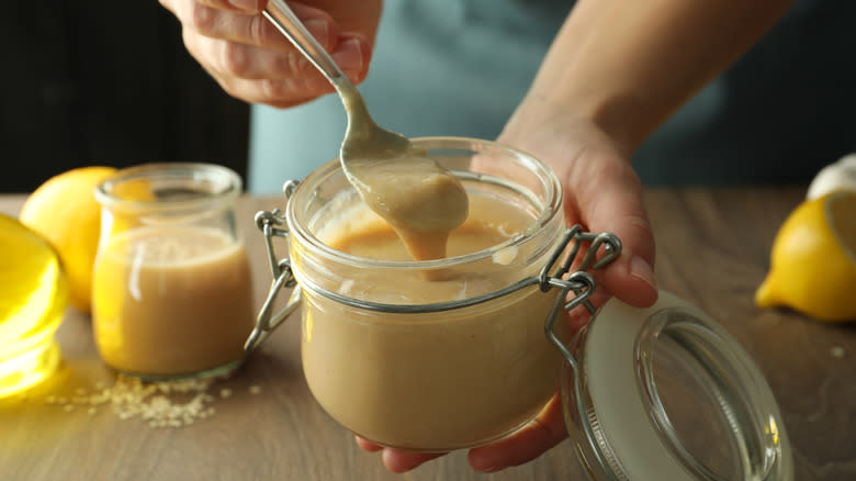 Woman holding a tahini jar