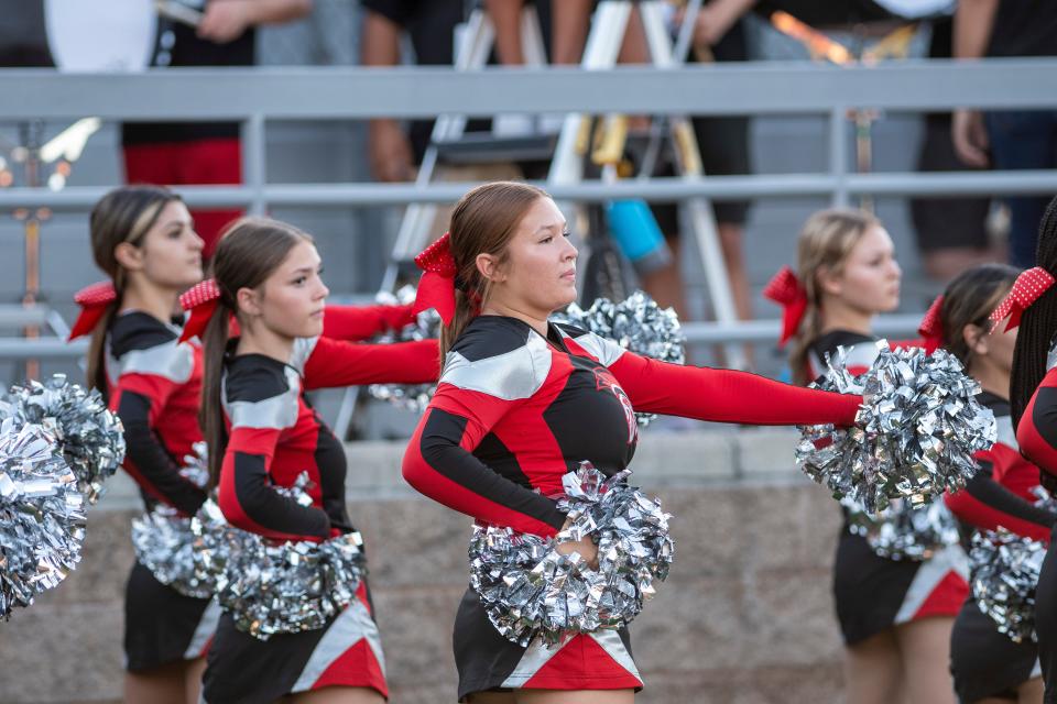 Lincoln High cheerleaders perform before the game against Downey High, Friday August 19 2022.