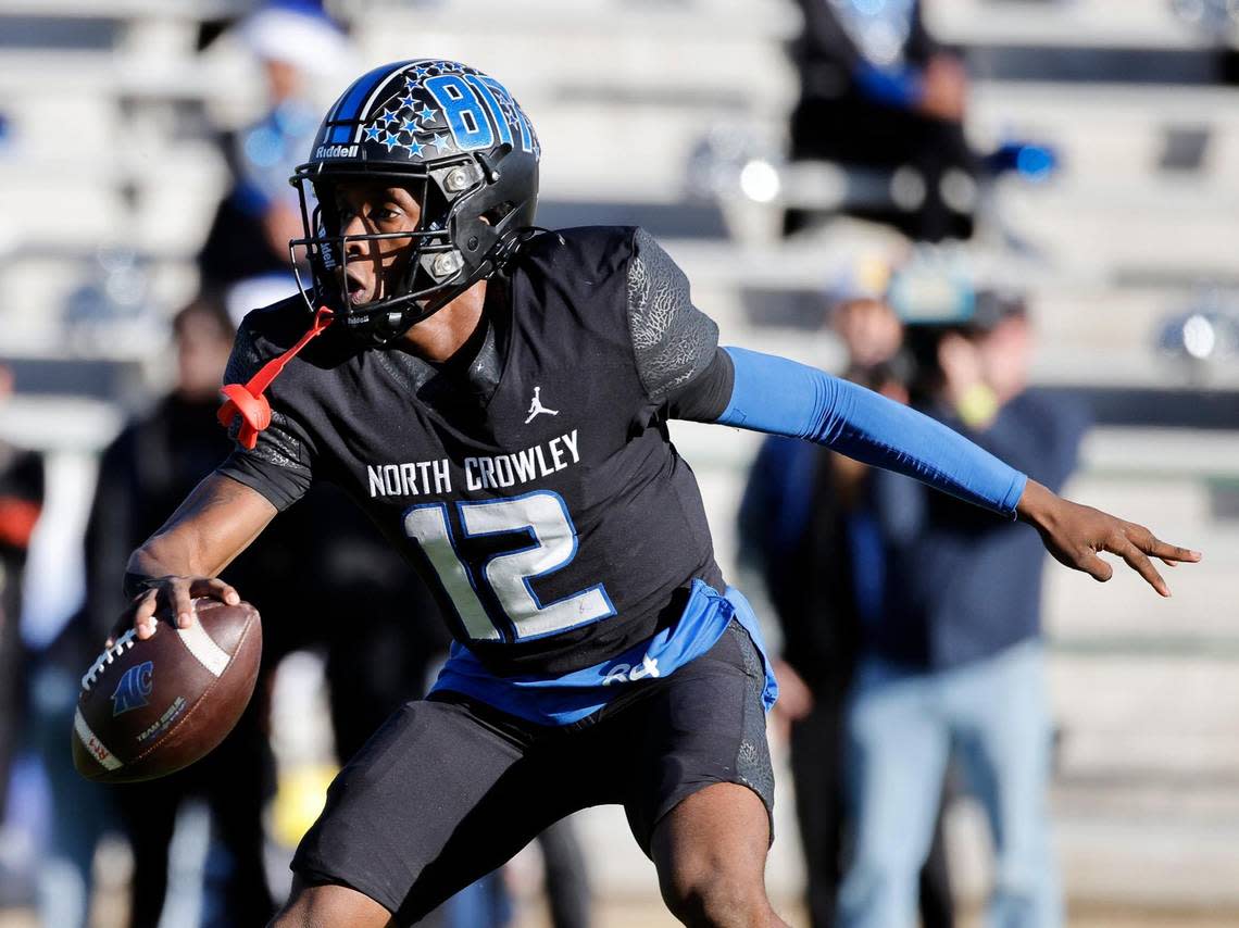 North Crowley quarterback Chris Jimerson (12) scrambles in the backfield during the first half of a UIL Conference 6A Division I state semifinal football playoff game at Mesquite Memorial Stadium in Mesquite, Texas, Saturday, Dec. 09, 2023. Duncanville led North Crowley 24-0 at the half.