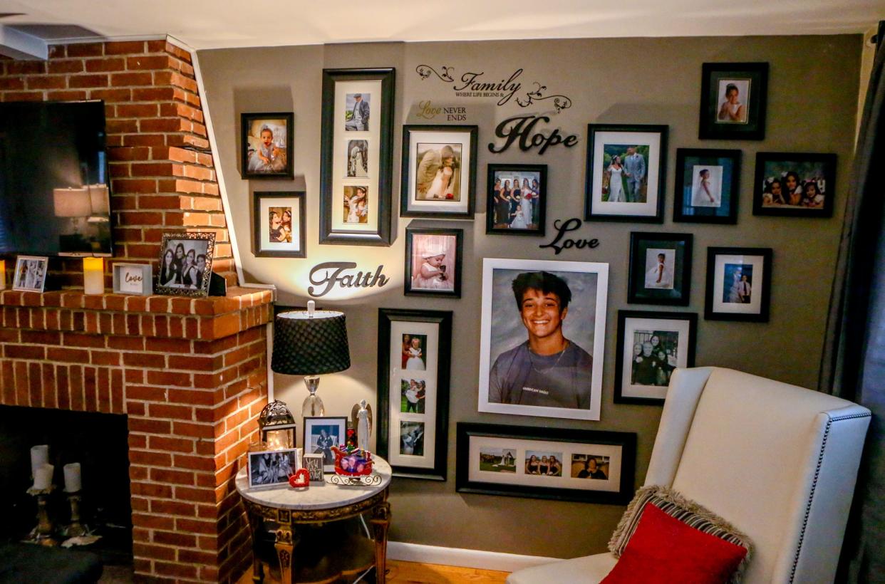 Photos of Olivia Passaretti and her family in the living room at the family's home in East Greenwich.