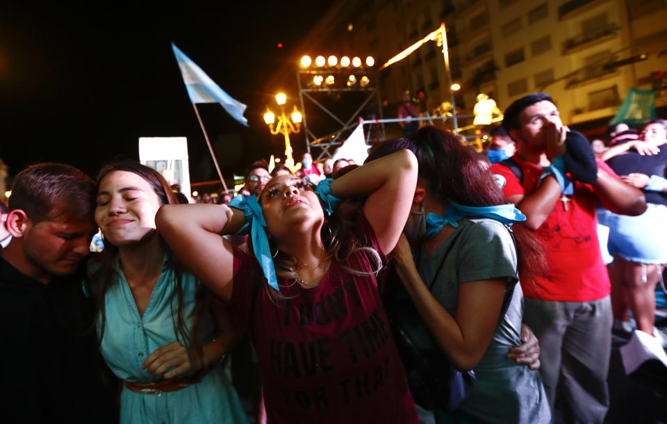 FILE - In this Dec. 30, 2020 file photo, anti-abortion activists react after lawmakers passed a bill that legalizes abortion, outside Congress in Buenos Aires, Argentina. The abortion law goes into force Sunday, Jan. 24, 2021. The vote was hailed as a triumph for the country’s feminist movement, but church leaders criticized the decision and its supporters say they expect lawsuits from anti-abortion groups in conservative provinces and some private health clinics might refuse to carry out the procedure. (AP Photo/Marcos Brindicci, File)