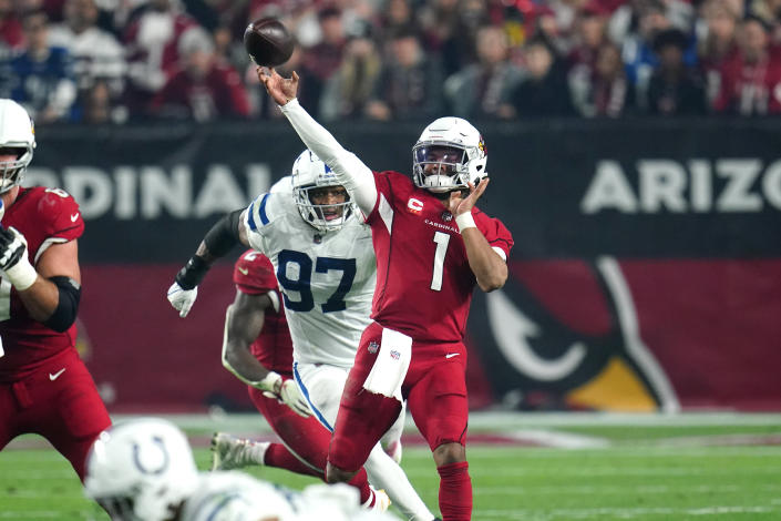 dArizona Cardinals quarterback Kyler Murray (1) throws as Indianapolis Colts defensive end Al-Quadin Muhammad (97) pursues during the second half of an NFL football game, Saturday, Dec. 25, 2021, in Glendale, Ariz. (AP Photo/Ross D. Franklin)