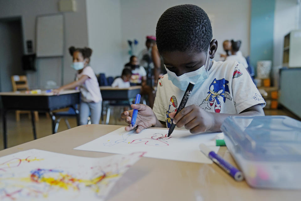 Caleb Taylor, 5, works on his art work during a class at Chalmers Elementary school in Chicago, Wednesday, July 13, 2022. America's big cities are seeing their schools shrink, with more and more of their schools serving small numbers of students. Those small schools are expensive to run and often still can't offer everything students need (now more than ever), like nurses and music programs. Chicago and New York City are among the places that have spent COVID relief money to keep schools open, prioritizing stability for students and families. But that has come with tradeoffs. And as federal funds dry up and enrollment falls, it may not be enough to prevent districts from closing schools. (AP Photo/Nam Y. Huh)