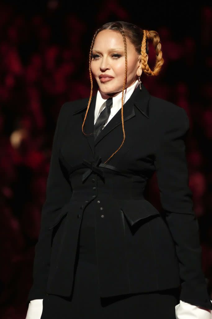 madonna at the grammy awards in 2023, in a black suit with her hair in raised pigtails