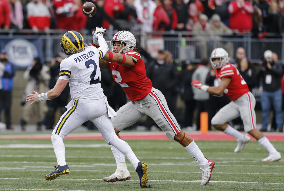 Ohio State defensive end Chase Young, right, pressures Michigan quarterback Shea Patterson during the second half of an NCAA college football game Saturday, Nov. 24, 2018, in Columbus, Ohio. Ohio State beat Michigan 62-39. (AP Photo/Jay LaPrete)