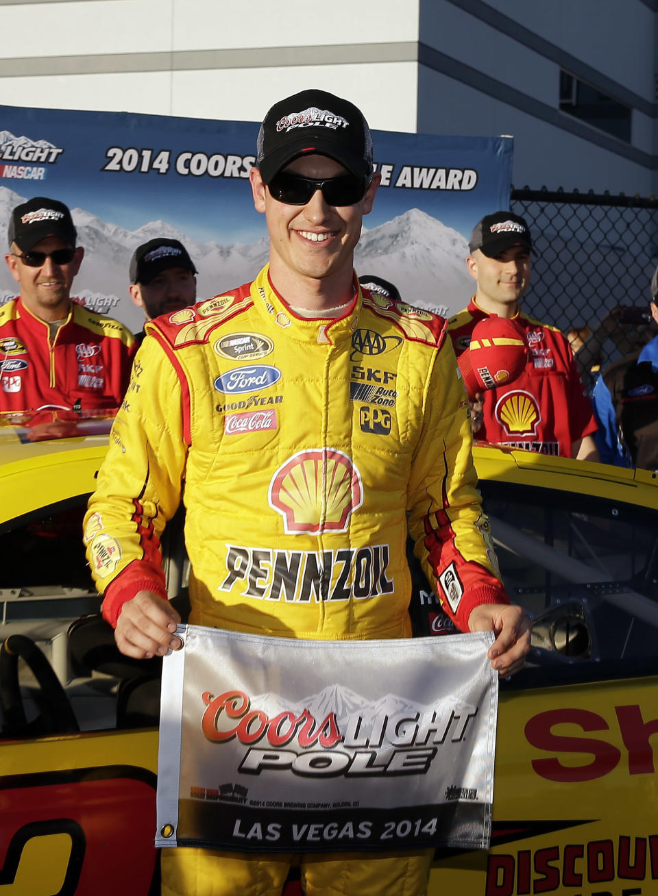 Joey Logano poses for photos after winning the pole position for Sunday'S NASCAR Sprint Cup Series auto race, Friday, March 7, 2014, in Las Vegas. (AP Photo/Isaac Brekken)