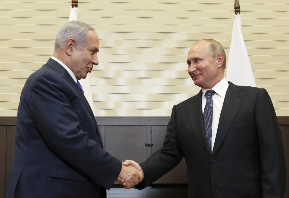 FILE - In this Sept. 12, 2019 file photo, Russian President Vladimir Putin, right, shakes hands with Israeli Prime Minister Benjamin Netanyahu during their meeting in Sochi, Russia. Netanyahu, locked in a razor tight race and facing the likelihood of criminal corruption charges, a decisive victory in Tuesday, Sept. 17, vote may be the only thing to keep him out of the courtroom.(Shamil Zhumatov/Pool Photo via AP, File)