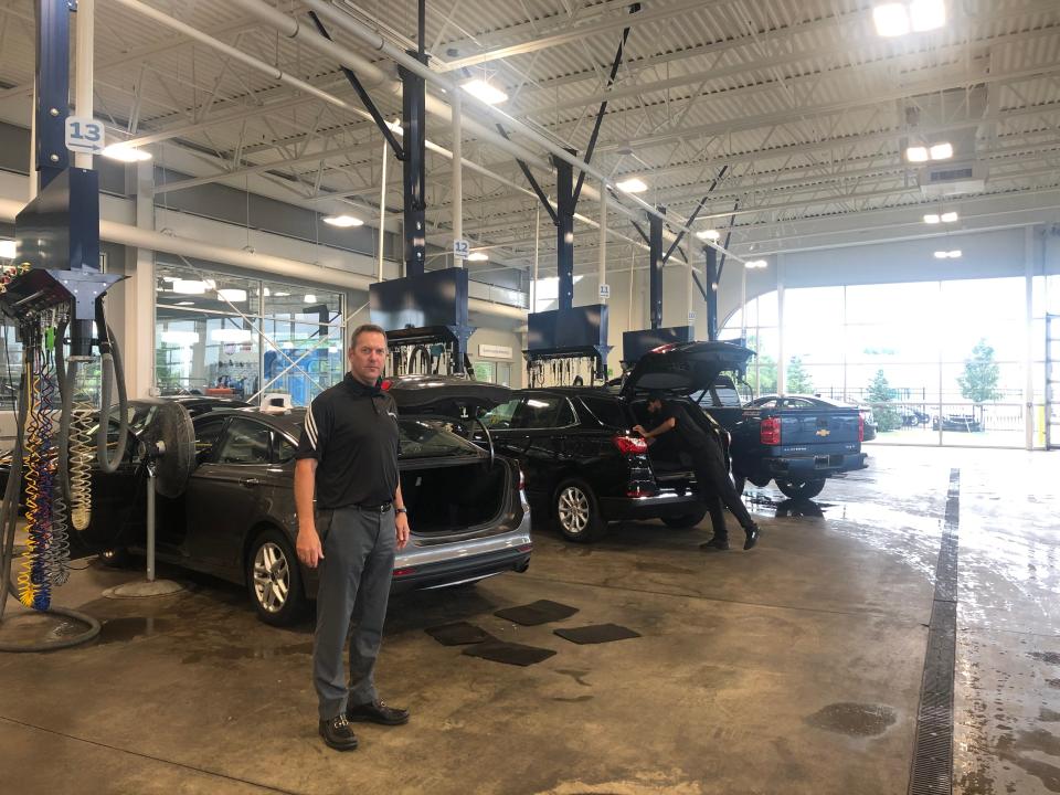 Paul Zimmermann, director of sales for Matick Automotive stands in Matick Chevrolet's detailing center where technicians have to use machines to get smoke smell out of used cars.