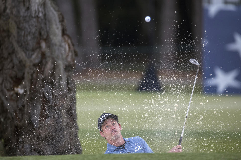 Andrew Putnam hits out of a bunker on the 18th green during final round of the RSM Classic golf tournament, Sunday, Nov. 20, 2022, in St. Simons Island, Ga. (AP Photo/Stephen B. Morton)