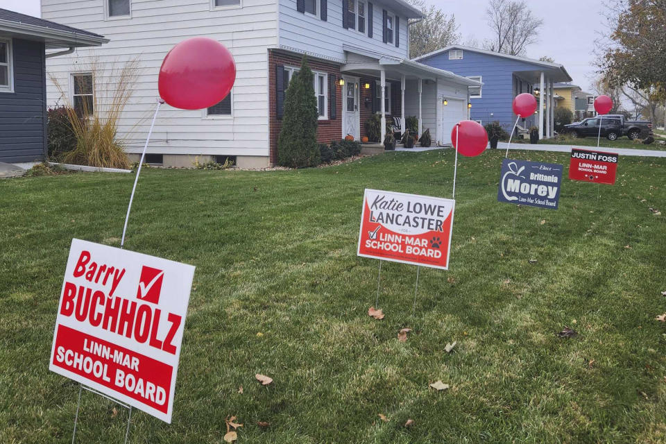 This photo provided by Mary Jo Carlson shows balloons attached to yard signs of four school board candidates who defeated Moms for Liberty-backed candidates in the Linn-Mar Community School District, located outside of Cedar Rapids, Iowa, Wednesday, Nov. 8, 2023. Voters across the U.S. largely rebuked conservative candidates on Tuesday, Nov. 7, in school board races across the country. (Mary Jo Carlson via AP)