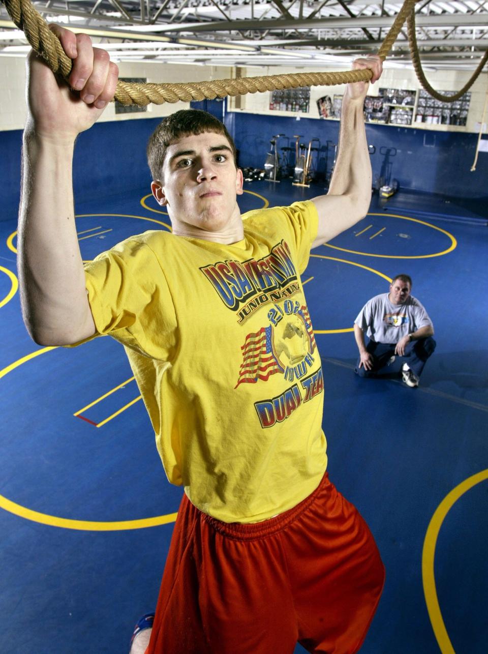 Don Bosco of Gilbertville's Mack Reiter entered the 2003 state tournament hoping to become the 13th wrestler to claim a fourth state title. His coach, at right, was Tom Kettman.