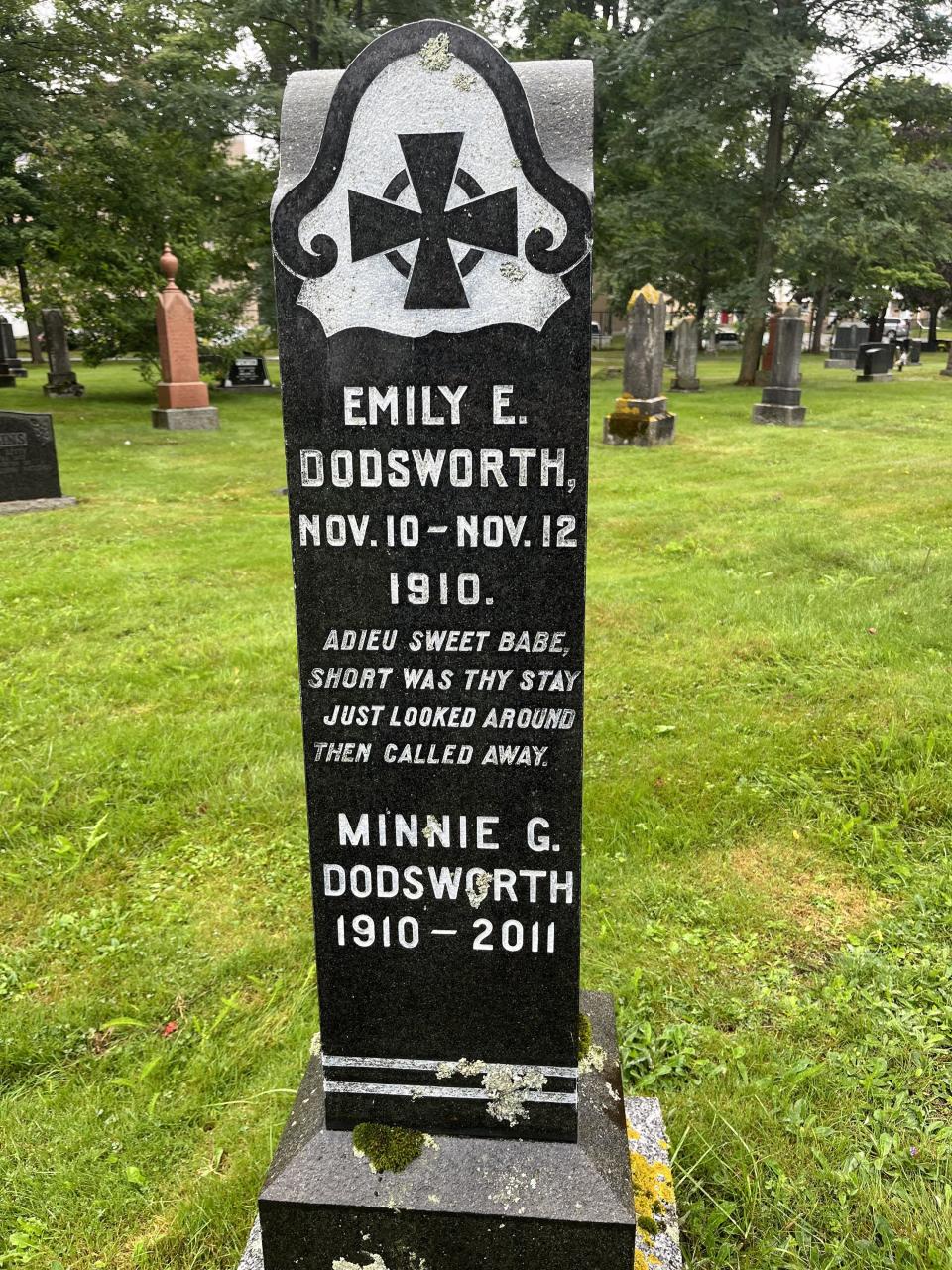 a tombstone that says Emily  Dodsworth nov 10-12, 1910 and Minnie Dodsworth 1910-2011