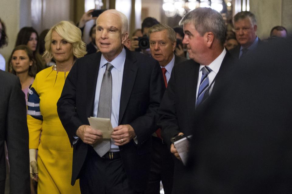 Sen.&nbsp;John McCain, second from left,&nbsp;leaves the Capitol after his first appearance since&nbsp;being diagnosed with cancer. He arrived to cast a vote to help Republican senators narrowly pass the motion to proceed&nbsp;for the replacement of the Affordable Care Act on July 25, 2017.