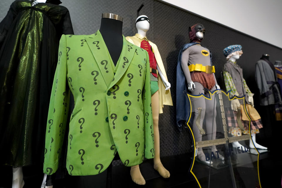 The Riddler's jacket and Batman and Robin's costumes are some of the items shown on display, Thursday, April 27, 2023, in Irving, Texas. A dizzying number of props, sets, and costumes from television shows beloved by generations of viewers will be sold at auction next month. The collection James Comisar has spent over 30 years amassing includes "The Tonight Show" set Johnny Carson gave him after retiring, the timeworn living room from "All in the Family," and the bar where Sam Malone served customers on Cheers. (AP Photo/Tony Gutierrez)