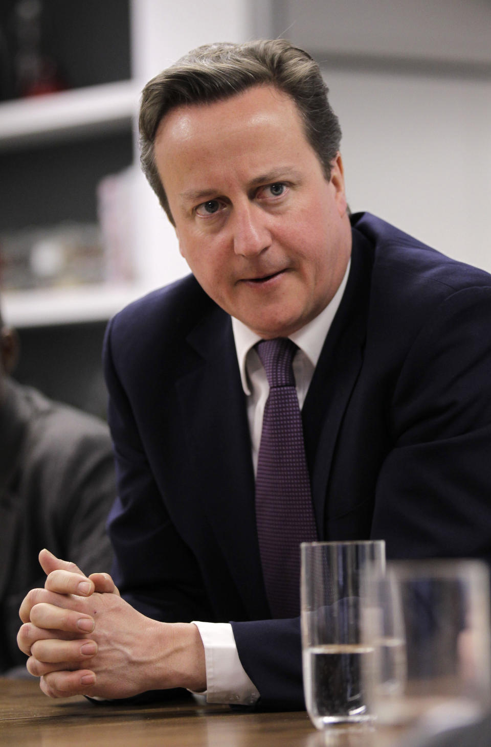 FILE - In this Wednesday, April 4, 2012 file photo British Prime Minister David Cameron meets with social entrepreneurs at the Brigade as part of his launch of Big Society Capital, London. (AP Photo/Sang Tan, Pool, File)