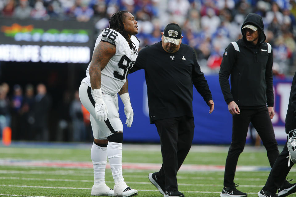 Trainers help Las Vegas Raiders defensive tackle Darius Philon (96) walk off the field after he was hurt during the second half of an NFL football game against the New York Giants, Sunday, Nov. 7, 2021, in East Rutherford, N.J. (AP Photo/John Munson)