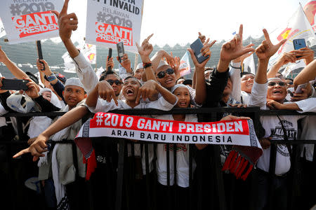 Supporters shout slogans as they hold placards with "2019 Change President" written on them while attending a campaign rally of Indonesia's presidential candidate Prabowo Subianto and his running mate Sandiaga Uno at Gelora Bung Karno Main Stadium in Jakarta, Indonesia, April 7, 2019. REUTERS/Willy Kurniawan