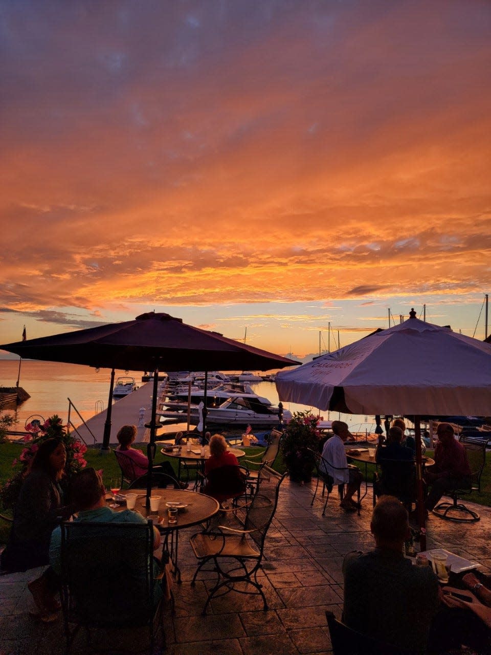 Patrons enjoy dinner against the backdrop of a stunning sunset at Waterfront Restaurant in Sister Bay. The restaurant is open seasonally and has a dock for customers arriving by boat. 