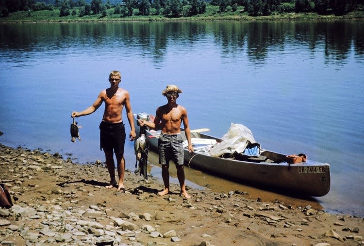 Bill Malcuit, left, holds a turtle while Jim Ecenbarger holds a bird during their canoe trip from Dover to New Orleans.