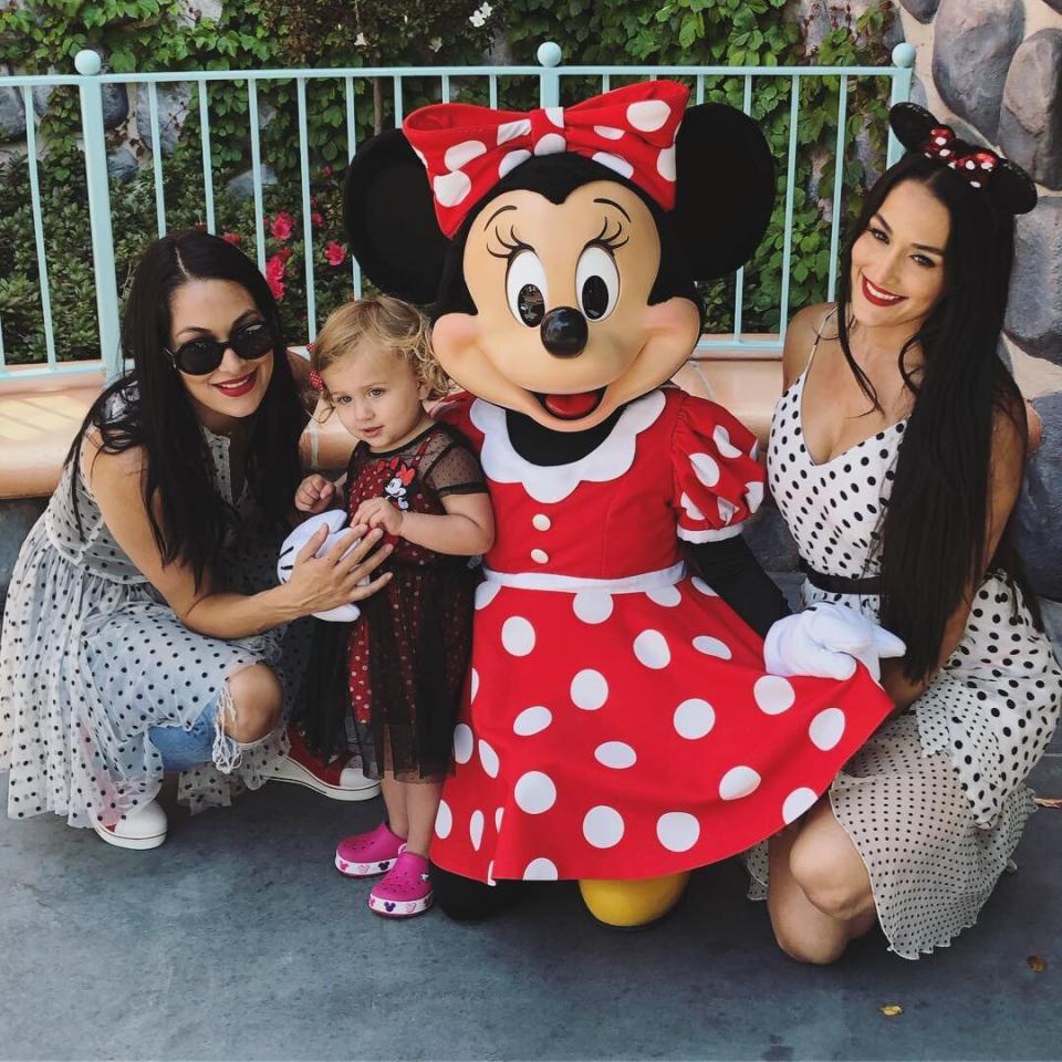 Even more than being a mini-me, Birdie <em>really</em> loves Minnie Mouse — and got to meet (and match!) the famous character herself during a trip to Disneyland to celebrate her 2nd birthday. Brie and Nikki, who are no strangers to matching looks themselves, coordinated in black-and-white polka-dot dresses for the occasion. 