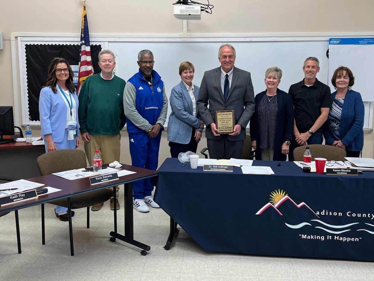 Madison County Schools Superintendent Will Hoffman holds the Western Region Superintendent of the Year plaque awarded to him March 26.