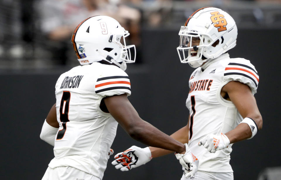 Idaho State wide receiver Jalen Johnson (9) celebrates with teammate and fellow wide receiver Xavier Guillory (1) after scoring a touchdown during the first half of an NCAA college football game against UNLV at Allegiant Stadium, Saturday, Aug. 27, 2022, in Las Vegas. (Steve Marcus/Las Vegas Sun via AP)
