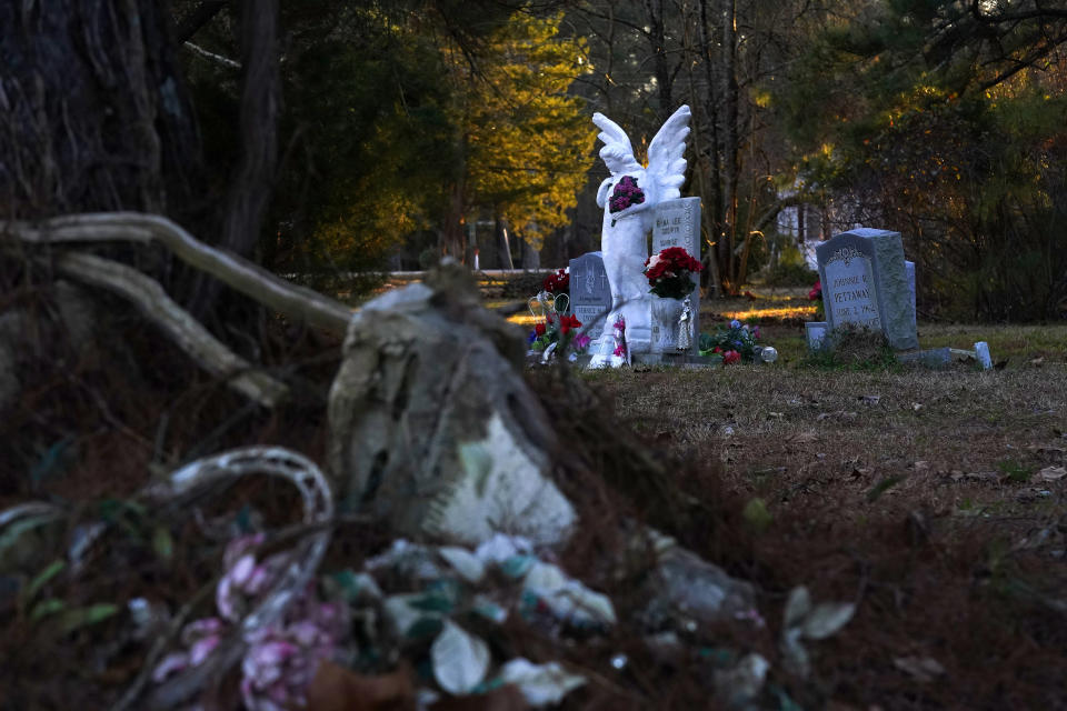 The town cemetery in Princeville, N.C., is a reminder of the permanent damage to the small community Monday, Feb. 28, 2022. Strewn cinder blocks can still be seen from past flooding, where some caskets were found floating in the community. (AP Photo/Gerry Broome)