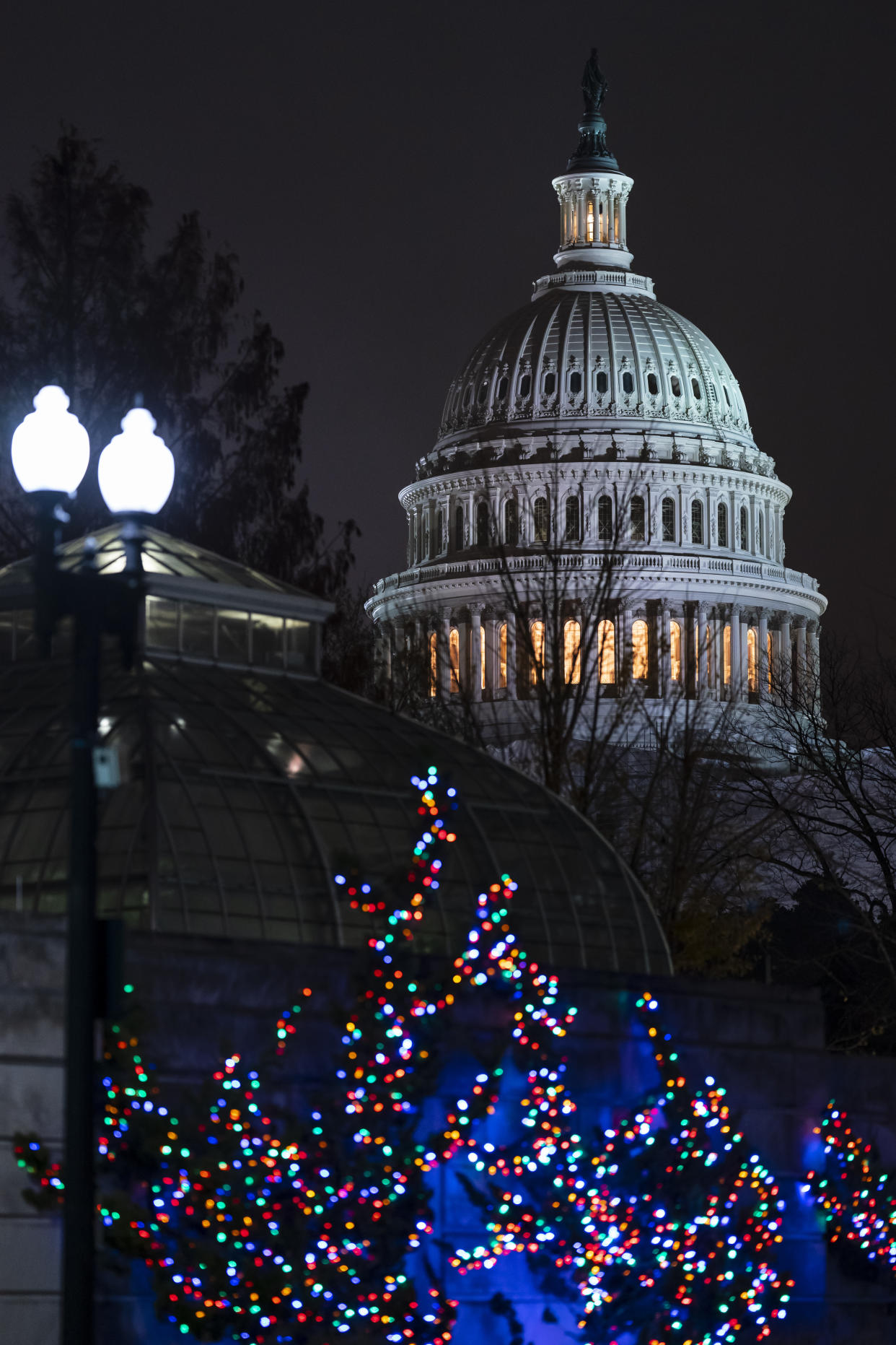 The Capitol is seen amid holiday lights Wednesday evening as the House of Representatives works to approve the Respect for Marriage Act, a bill already passed in the Senate to codify both interracial and same-gender marriage, in Washington, Dec. 7, 2022. (AP Photo/J. Scott Applewhite)