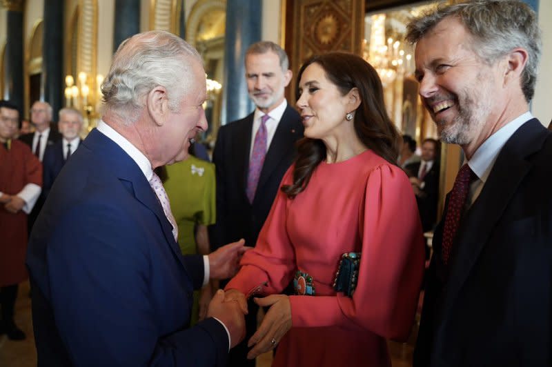 King Charles III (L) speaks to then-Crown Princess Mary and then-Crown Prince Frederik of Denmark at Buckingham Palace while attending Charles' May 2023 coronation in London, England. Charles and Frederik are cousins by blood along with multiple other European royal houses such as Spain, Belgium, Sweden and Norway. Photo by The Royal Family/UPI