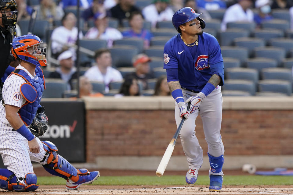 New York Mets catcher James McCann, second from left, and Chicago Cubs' Javier Baez, right, watch Baez's first-inning two-run home run during a baseball game, Thursday, June 17, 2021, in New York. (AP Photo/Kathy Willens)