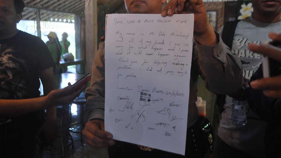 Kuta's police chief Ida Bagus Dedy Januarta holds a signed statement during a press conference, Kuta. Photo: AAP/Putra Sinulingga