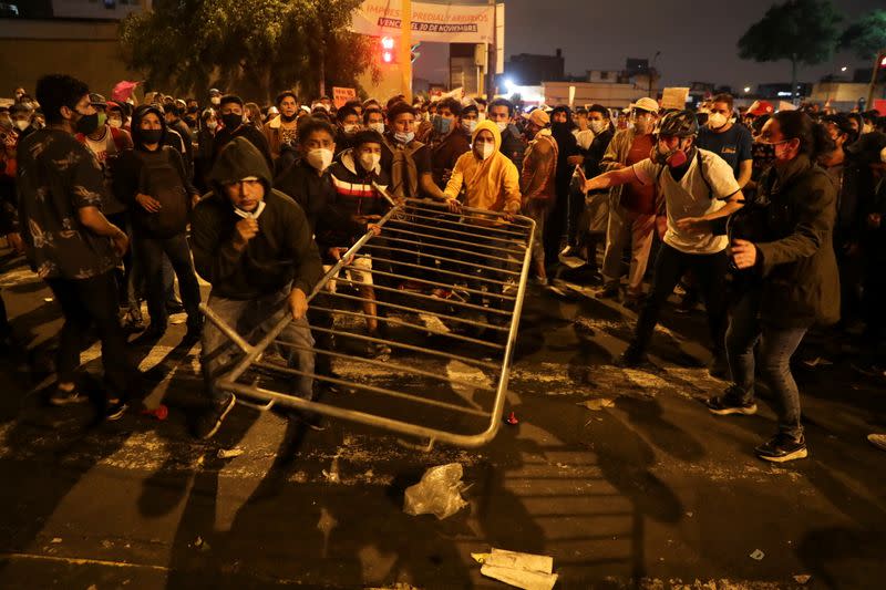 Demonstrators remove a barricade during protests following the impeachment of President Martin Vizcarra, in Lima