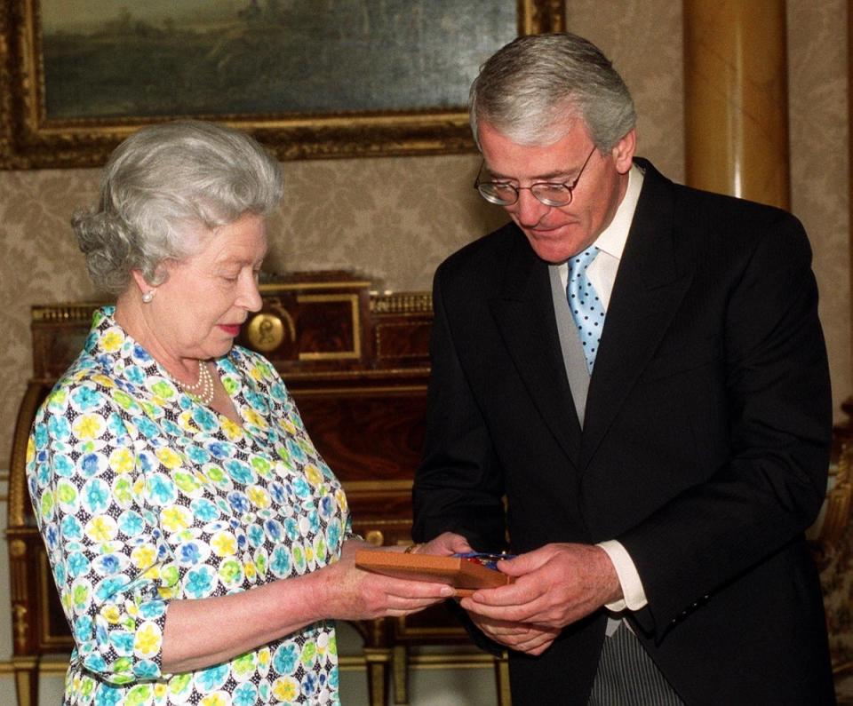 Former prime minister John Major receives the Companion of Honour from the Queen (Rebecca Naden/PA) (PA Archive)