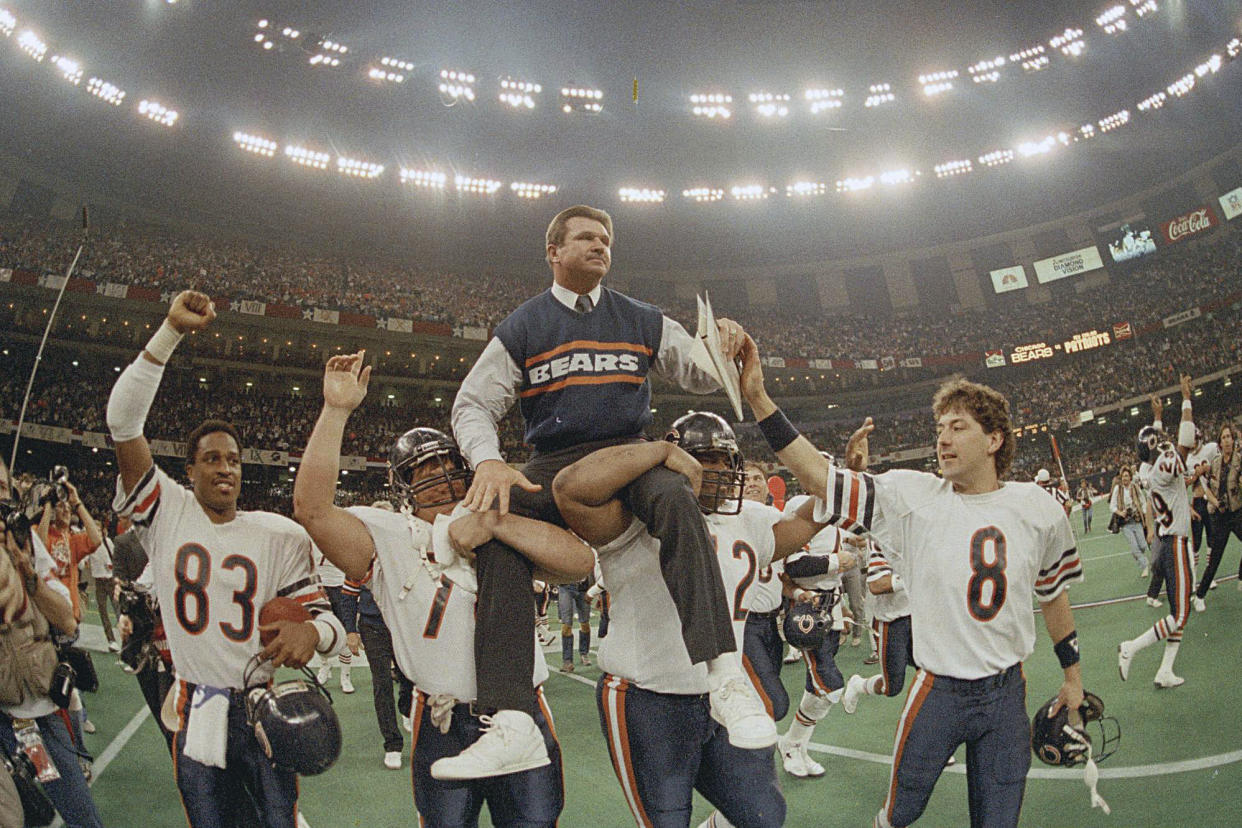 FILE - Chicago Bears head coach Mike Ditka is carried off the field by Steve McMichael, left, and William Perry after the team won Super Bowl XX against the New England Patriots in New Orleans on Jan. 26, 1986. A poll by The Associated Press and the NORC Center for Public Affairs Research conducted Sept. 9-12, 2022, finds that about 3 in 10 Americans say they feel God plays a role in determining which team goes home the victor. (AP Photo/Phil Sandlin, File)
