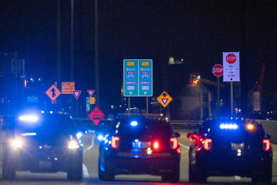 Police close a stretch of I-695 on the north end of the Francis Scott Key Bridge, a major span over the Patapsco River in Baltimore which collapsed after it was struck by a Singapore-flagged container ship 'Dali'.